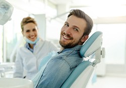 Man smiling while relaxing in treatment chair