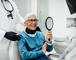Senior woman smiling while looking at reflection