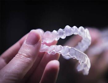 Clear aligners against dark background