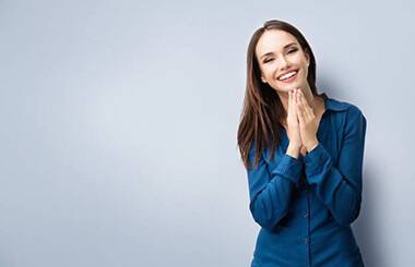 smiling woman in front of gray background