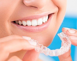 Closeup of patient holding Invisalign tray