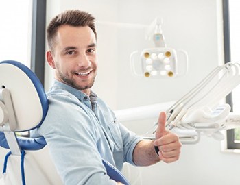 man giving thumbs up while visiting his dentist in Milwaukee 