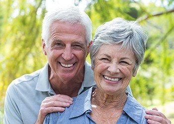 Senior man and woman smiling outdoors