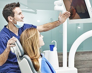 Dentist and patient looking at intraoral photos