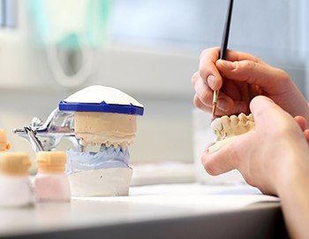 Lab worker crafting wax-up model