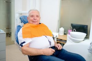 mature man smiling in dentist chair 