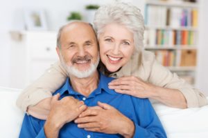 older couple smiling and hugging