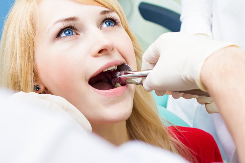 A woman receiving a tooth extraction