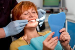 A woman examining her teeth.