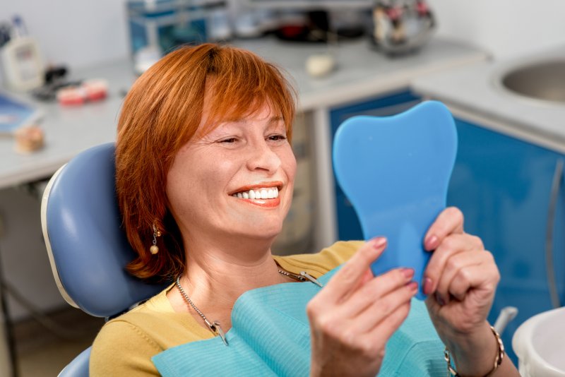 senior wearing set of dentures