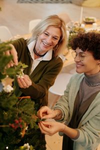 Two women decorating for the holidays